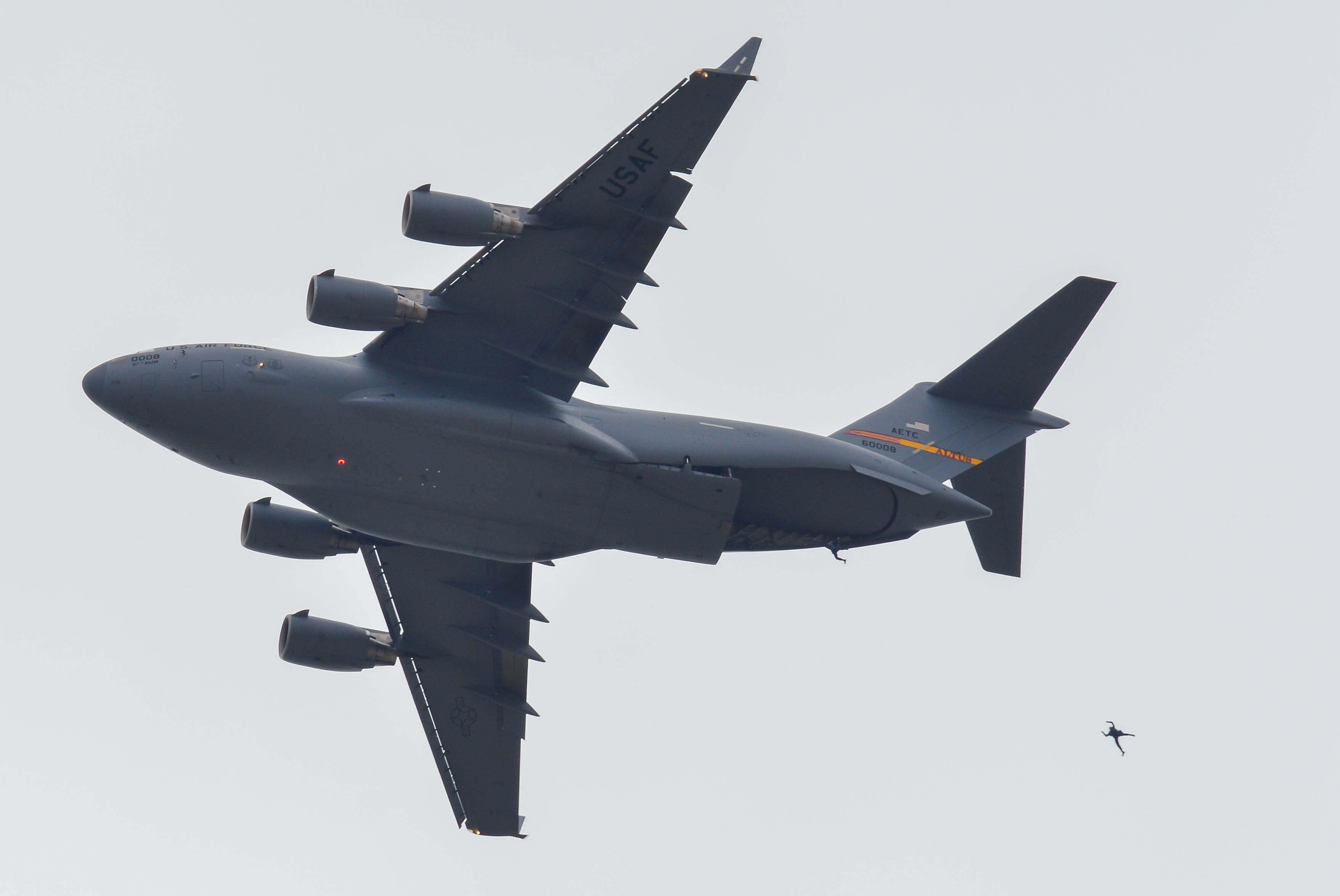 Two skydivers exiting the C-17